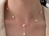 Sterling Silver Necklace. Delicate chain with pearls stationed along the front.