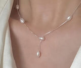 Sterling Silver Necklace. Delicate chain with pearls stationed along the front.