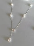 Sterling Silver Necklace. Delicate chain with pearls stationed along the front.